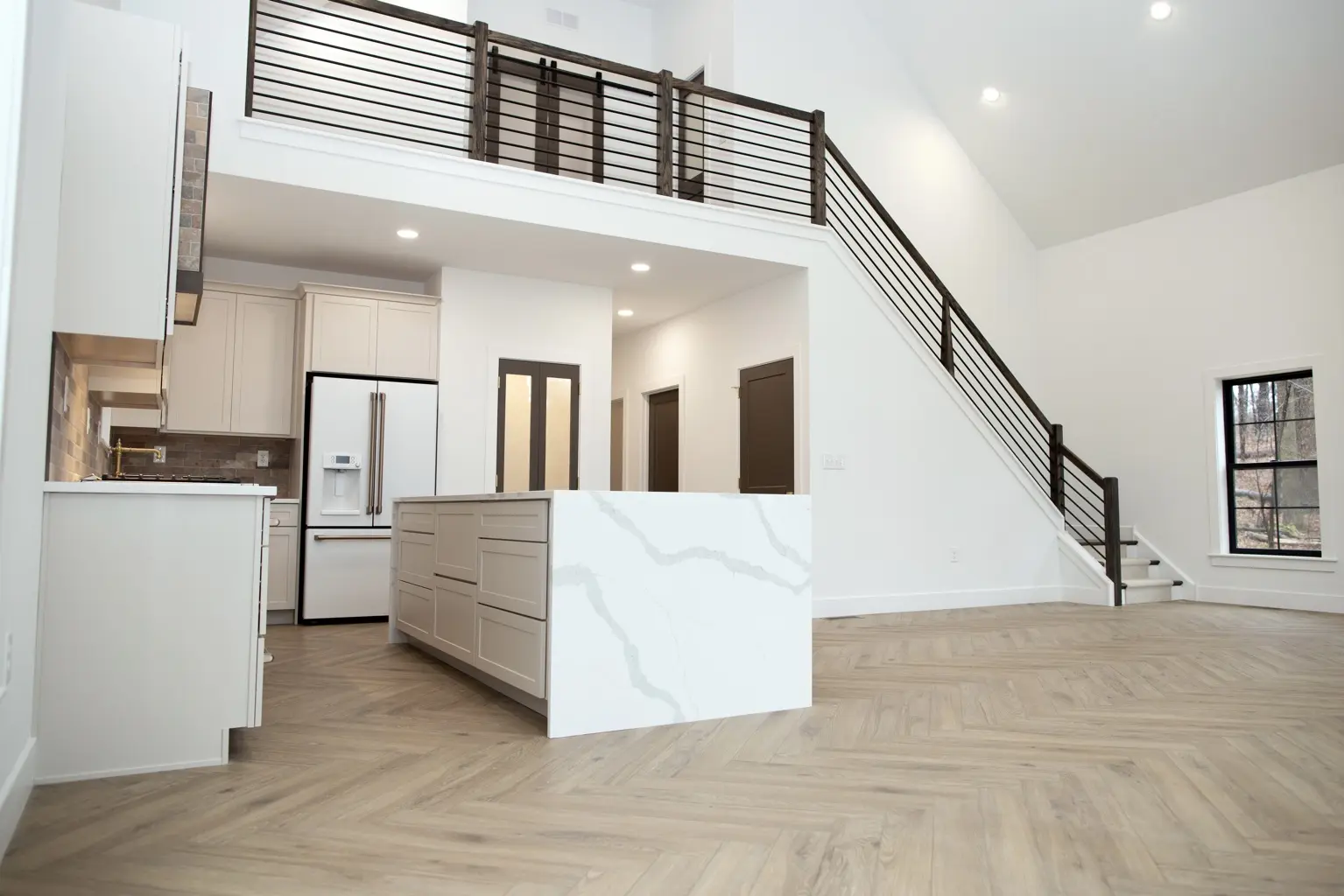 Custom home interior with an open kitchen and double-height living space